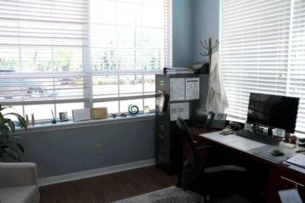 Office with desk, computer, and large windows
