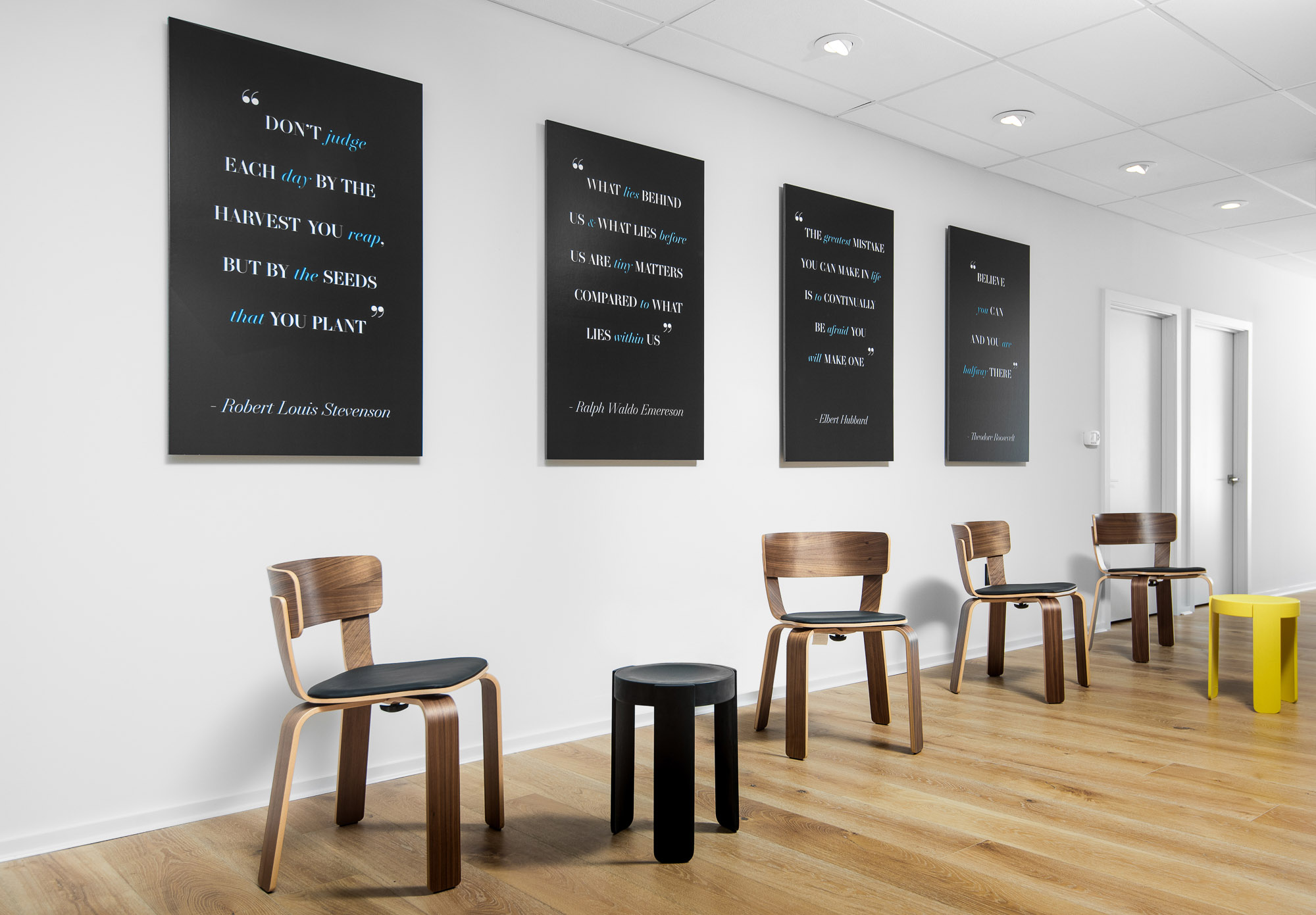 Modern wood chairs and quotes in a bright waiting room