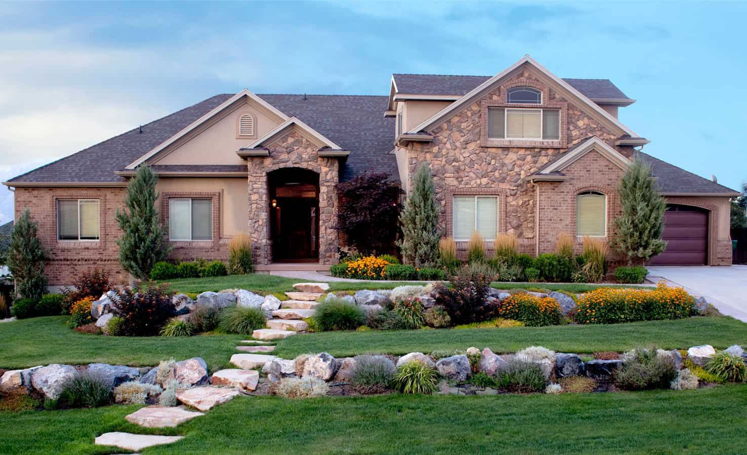 Stone-front residential facility with landscaped walkway.