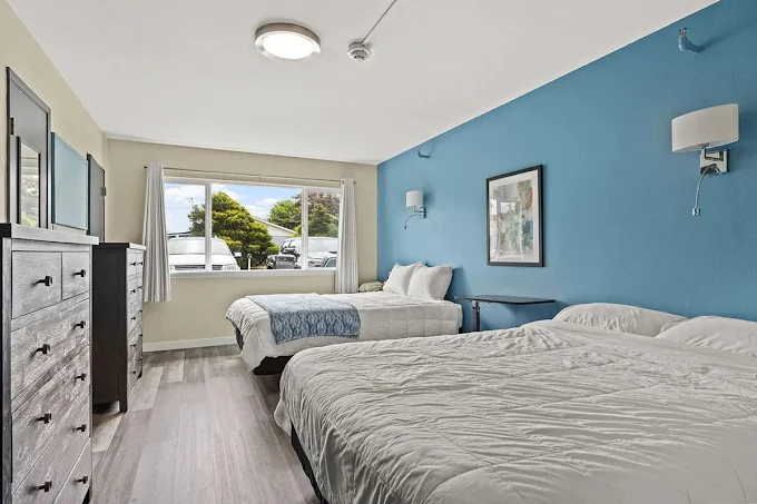 Bedroom with two beds and blue accent wall