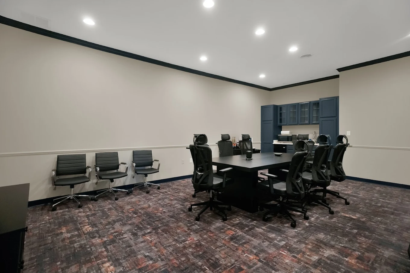 Conference room with large table and office chairs