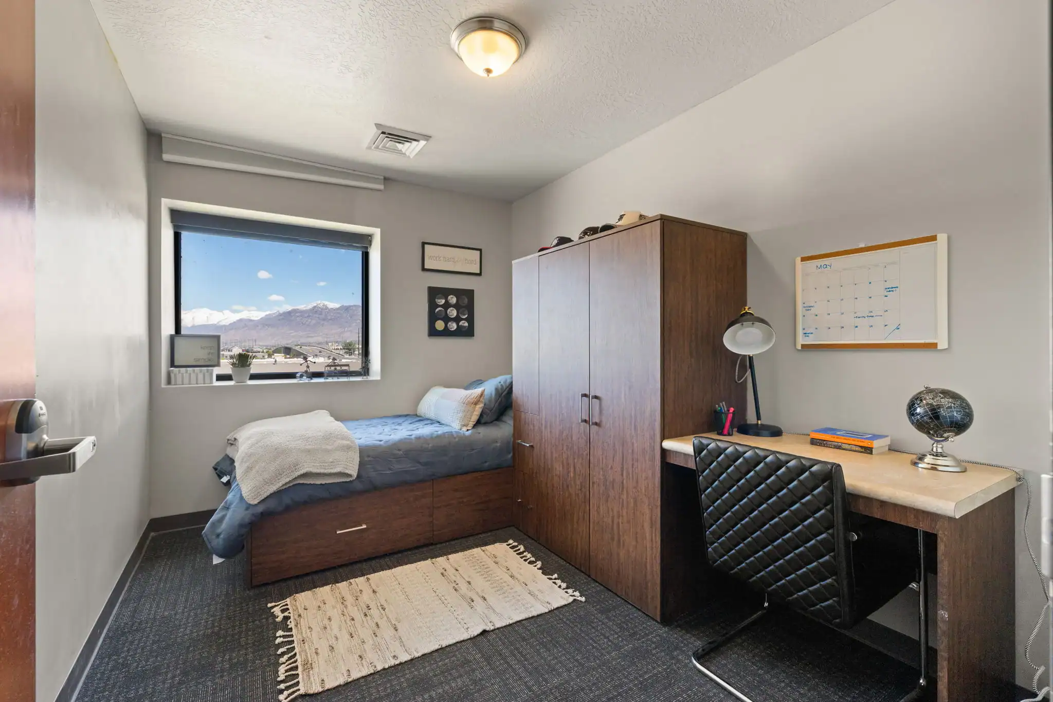 Private resident bedroom with desk and mountain view