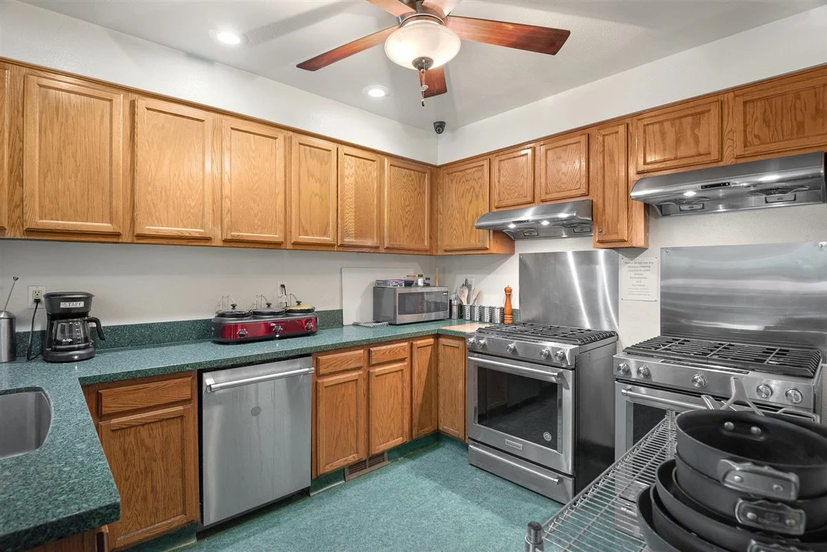 Rehab kitchen with wood cabinets and double ovens.