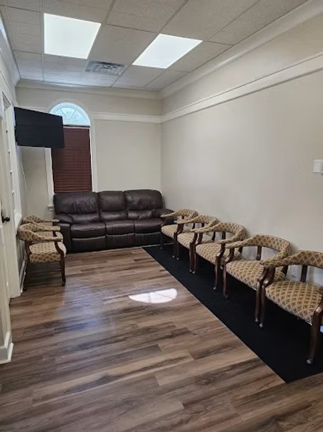 Waiting room with patterned chairs and a brown couch