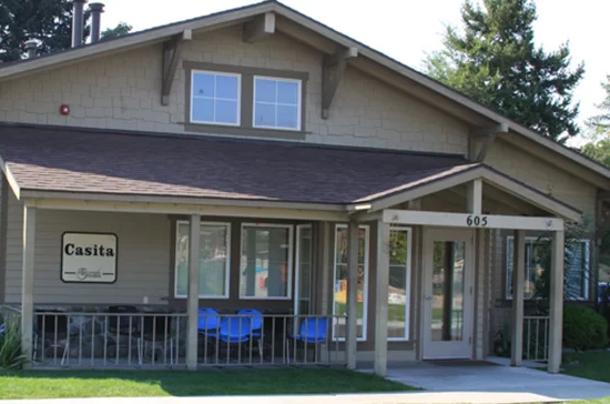 Front view of Casita building with porch and blue chairs