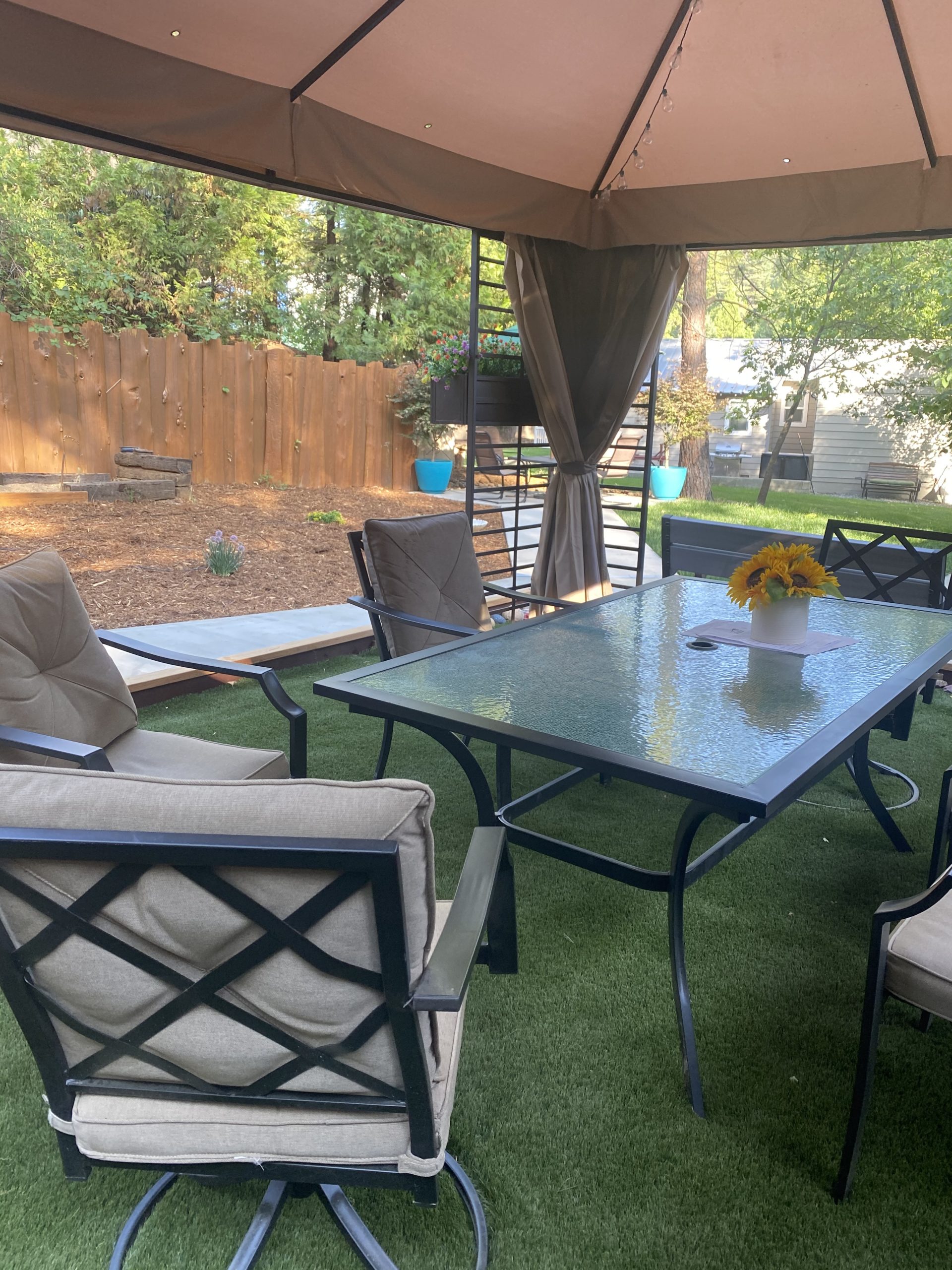 Covered outdoor lounge with table and seating at rehab facility