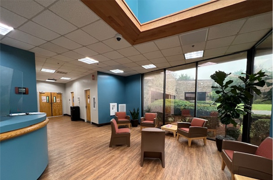 Bright waiting area with seating and large windows
