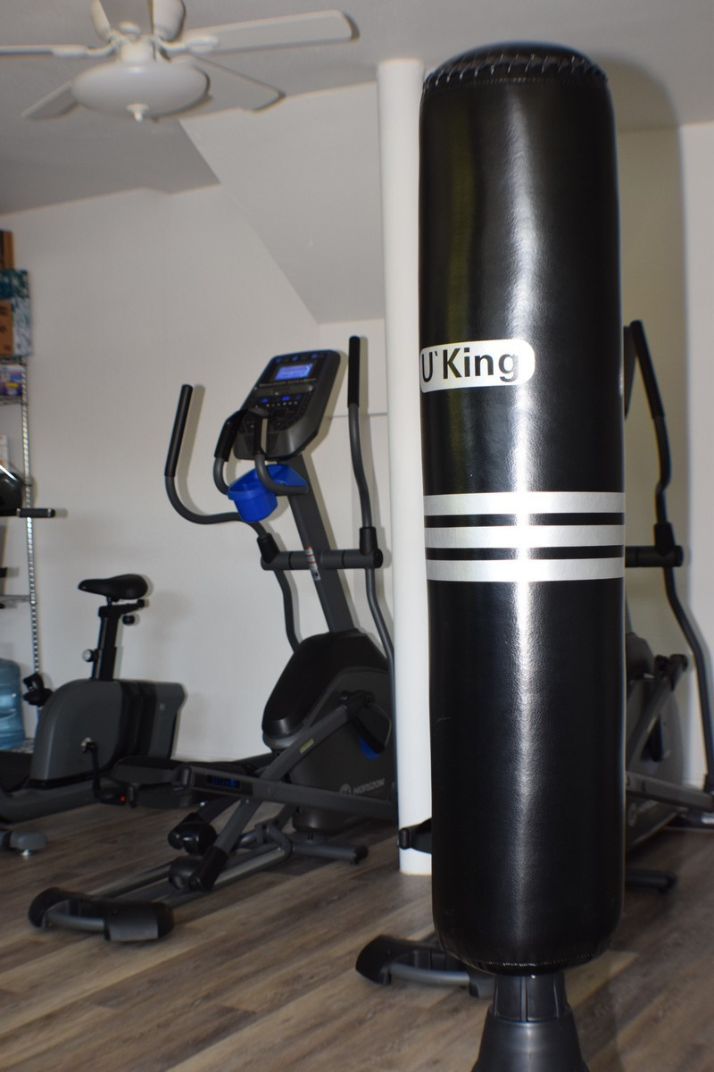 Fitness room with cardio machines and punching bag