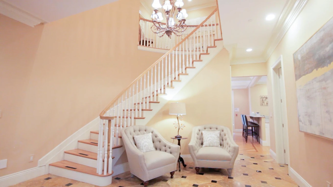 Grand foyer with staircase and comfortable seating area