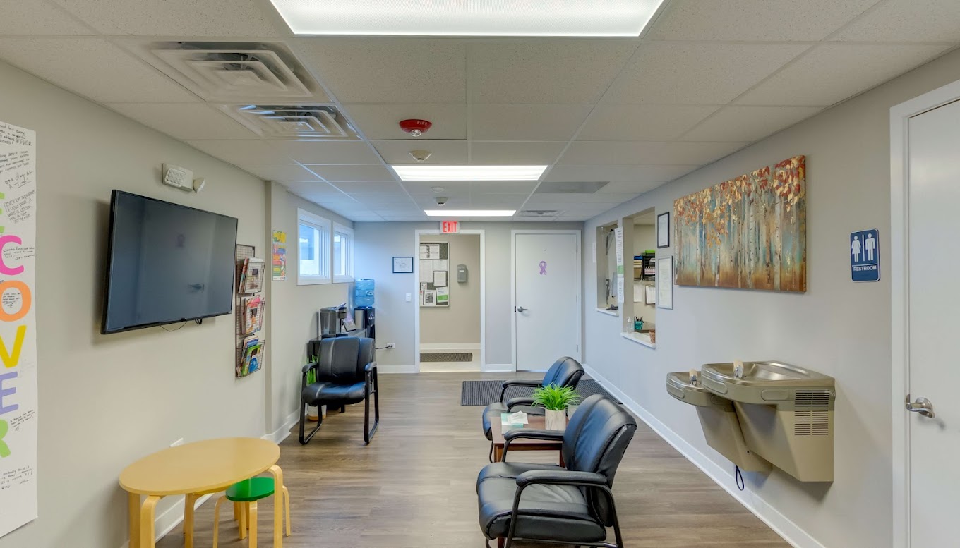 Lobby with chairs and reception desk.
