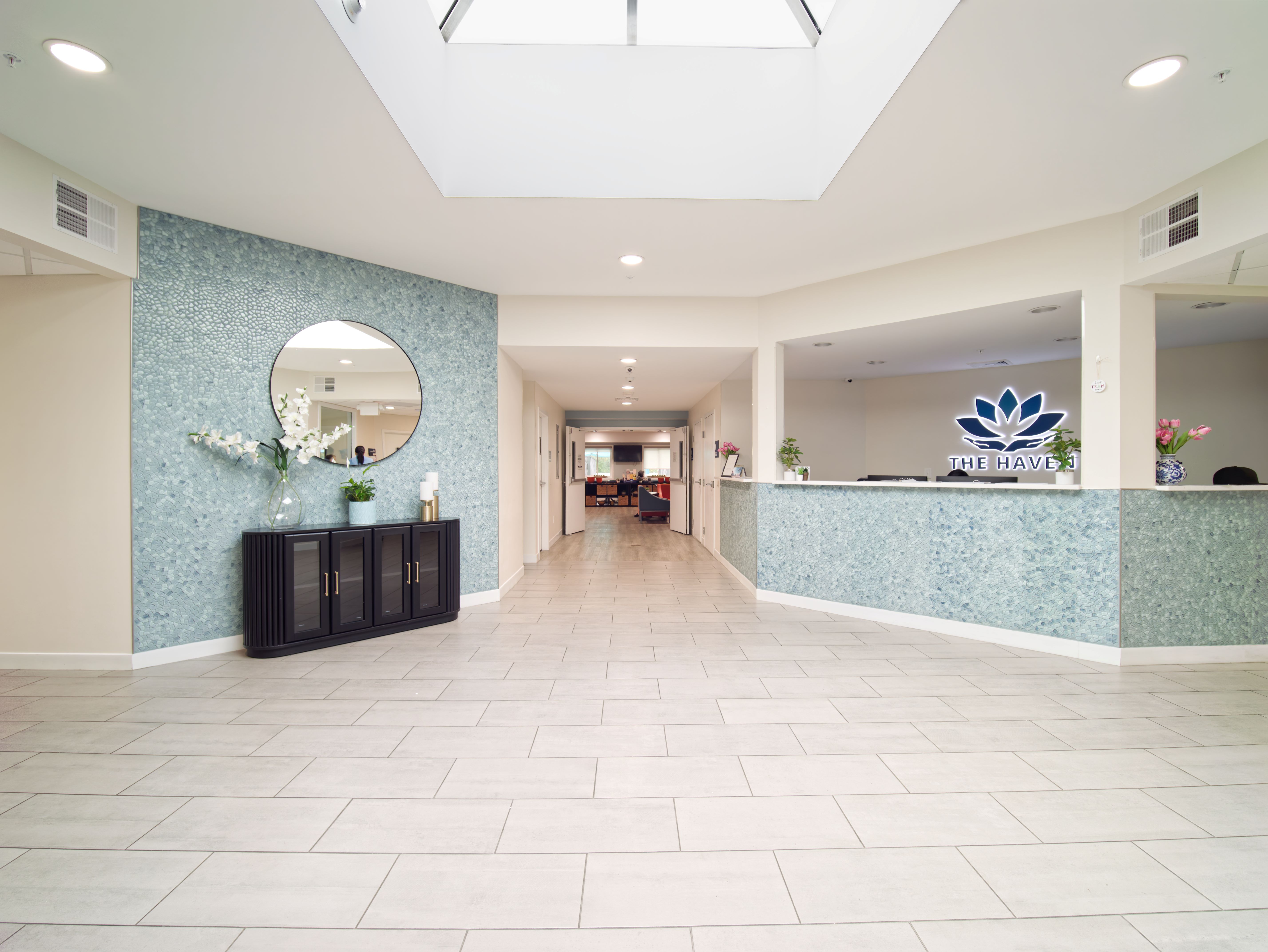 Spacious lobby with blue accent wall and reception desk.