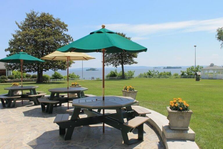 Patio with tables and umbrellas overlooking the water