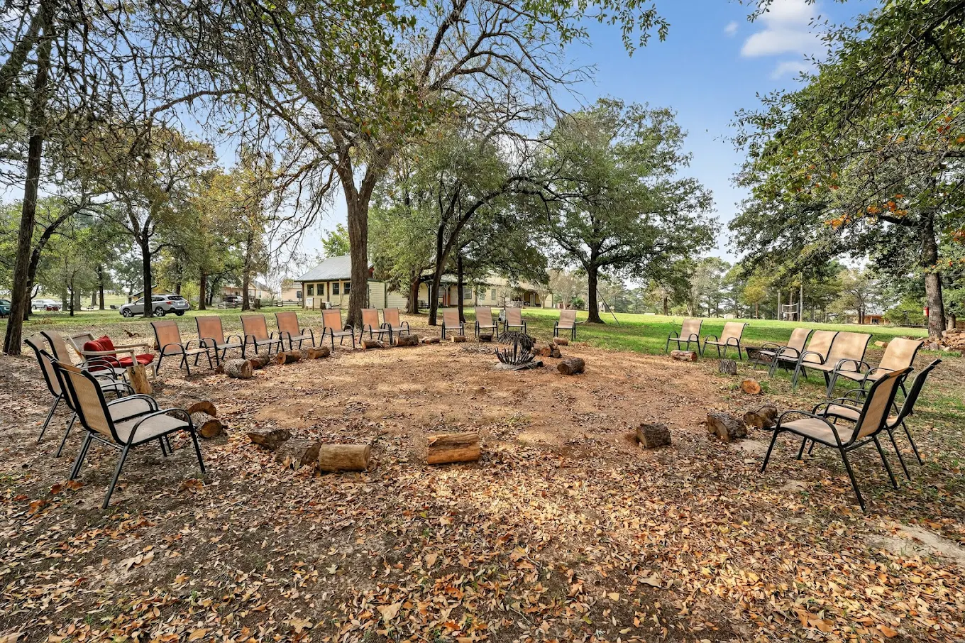 Circular seating area around an outdoor fire pit on the campus
