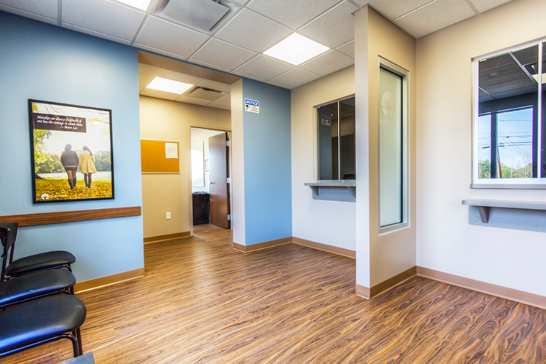 BrightView Ashtabula interior hall with service windows, blue accent walls, seating, and wood-look flooring
