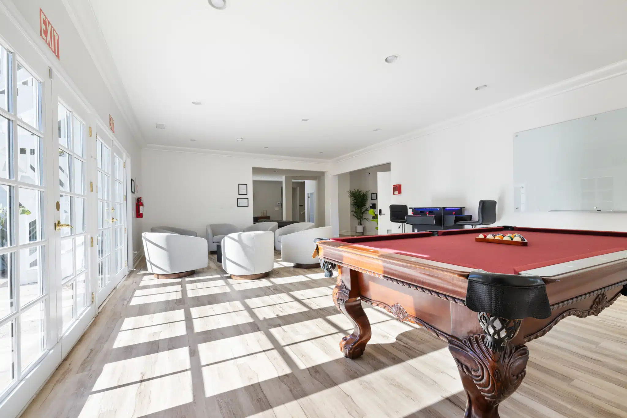 Bright lounge with pool table and casual seating.