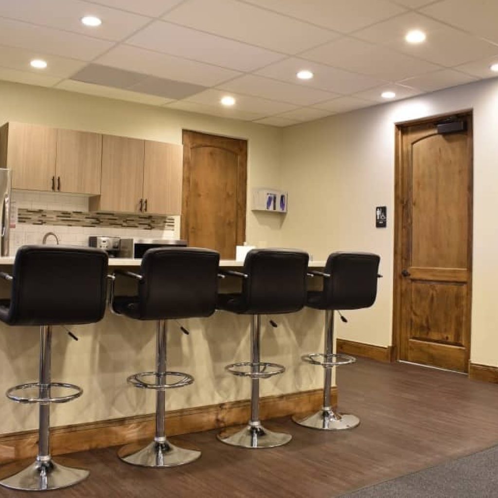Barstools at counter beside kitchenette