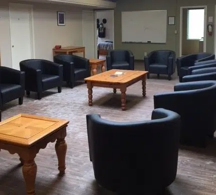 Group therapy room with circle of chairs and a whiteboard at Janus.