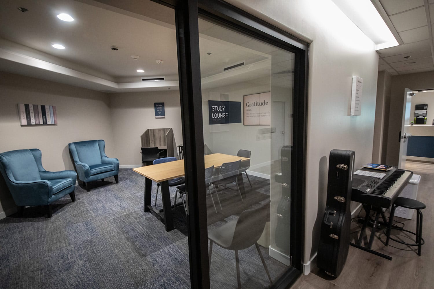 Quiet study lounge with desks, chairs, and private workspaces