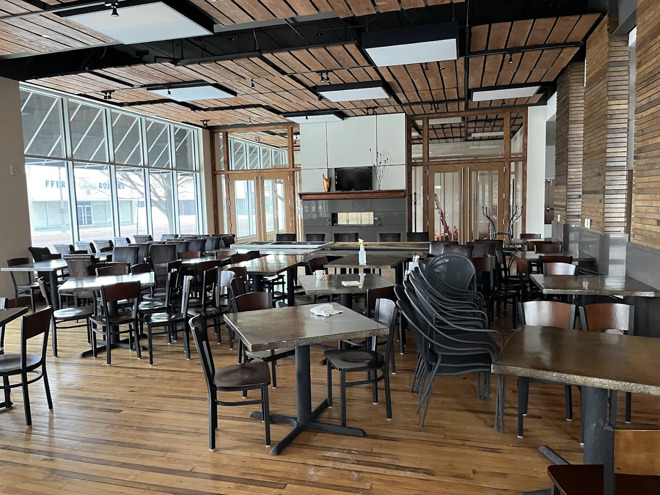 Spacious dining area with tables, chairs, and large windows