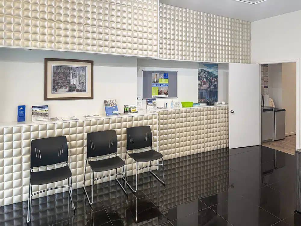 Chairs lined along wall with brochures and artwork