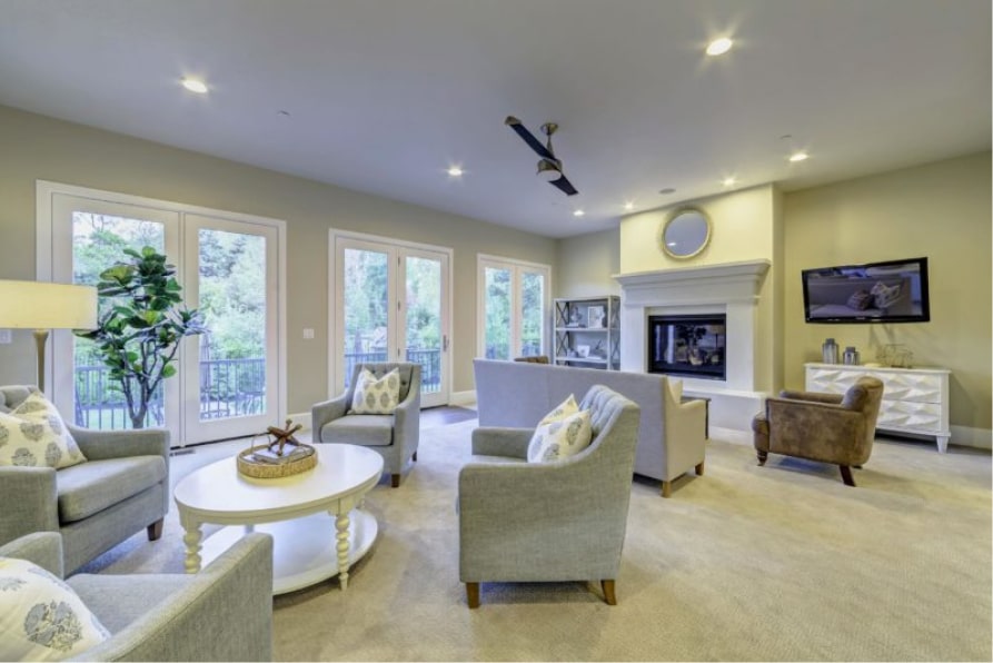 Common area with sofas, TV, fireplace, and large windows