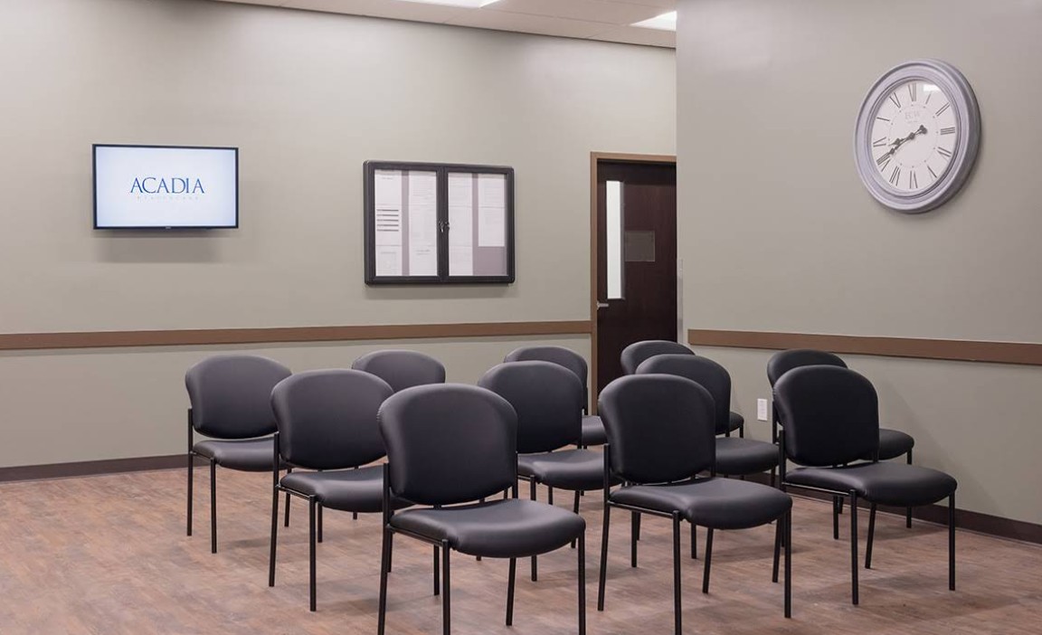 Group room with chairs, wall clock, and monitor
