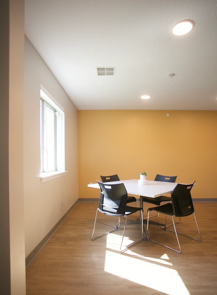 Small meeting room with table and four chairs