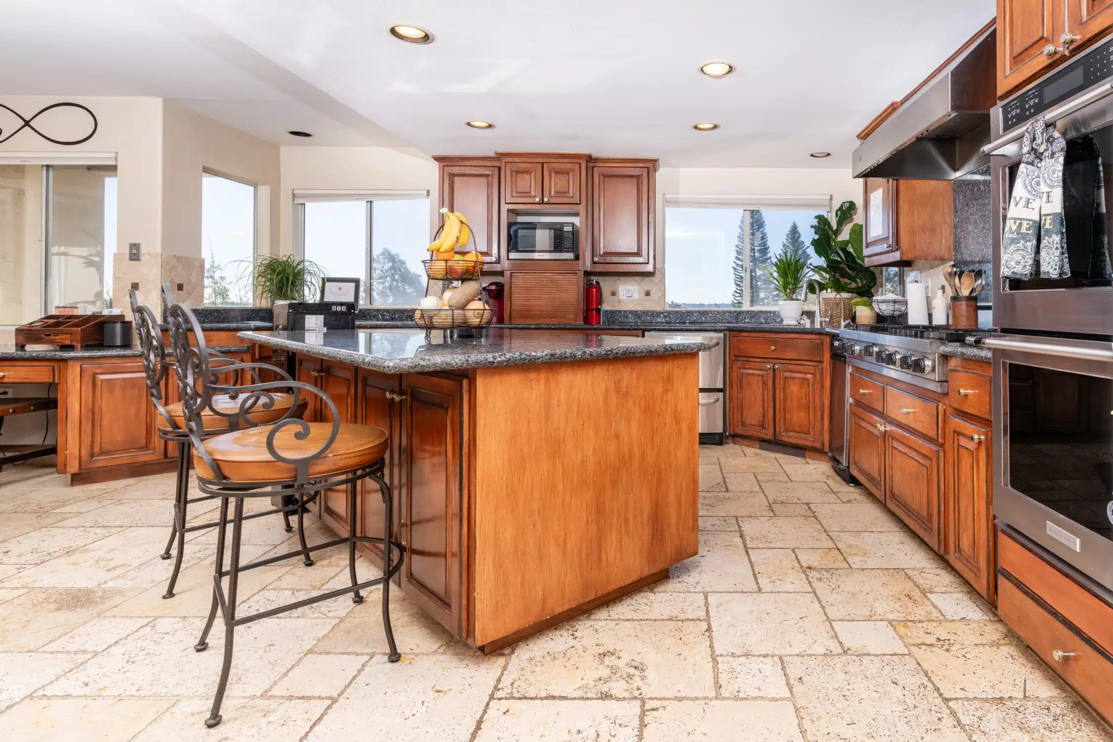 Spacious kitchen with wood cabinets and granite island
