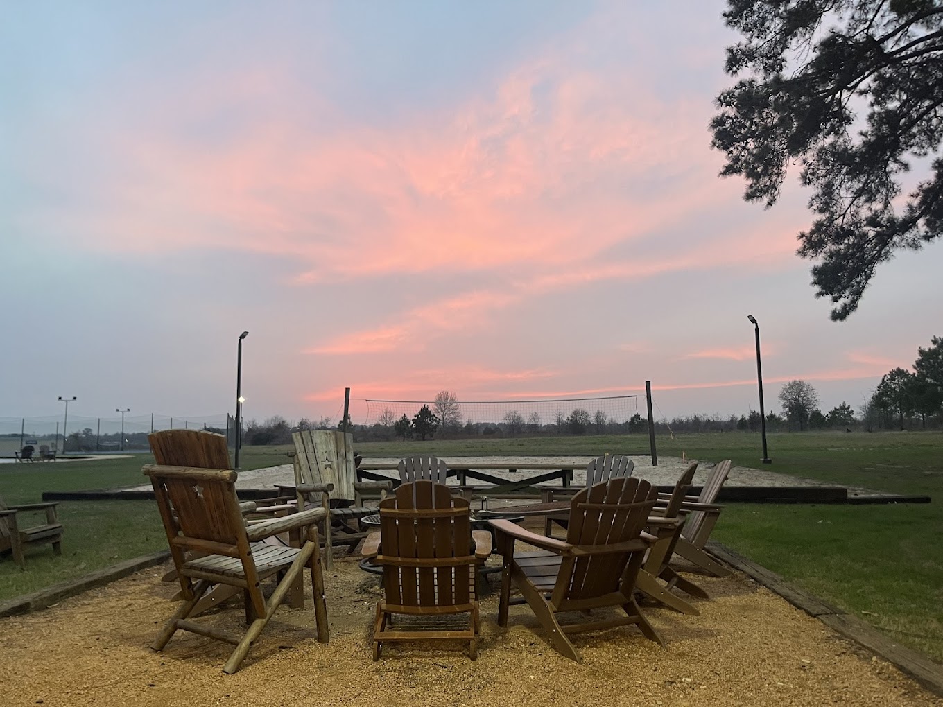 Outdoor chairs with a fire pit under.