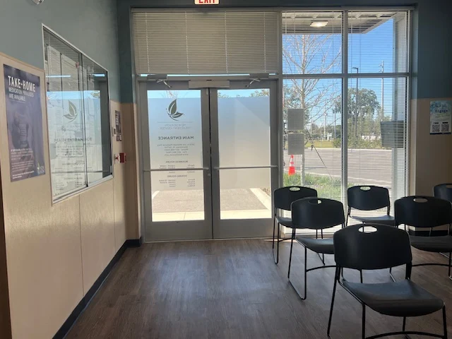 Glass entry doors and waiting chairs with outside view