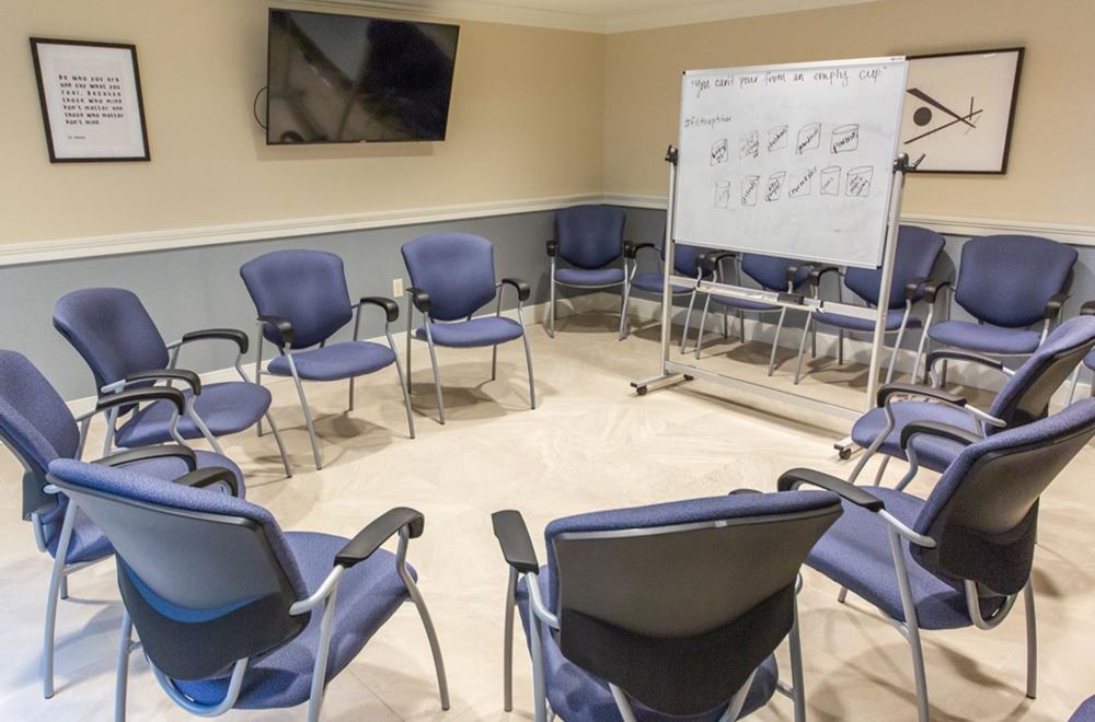 Group therapy room arranged with chairs in a circle.