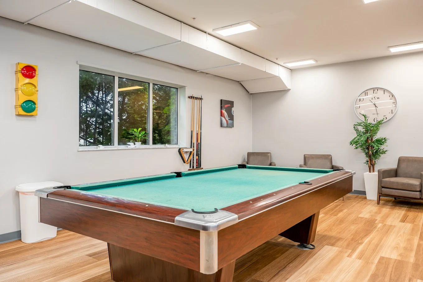 Billiards table with seating and wall decor
