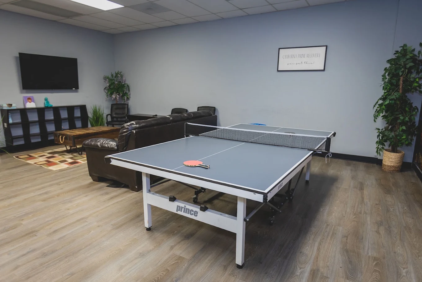 Recreation room with ping pong table, television, and seating