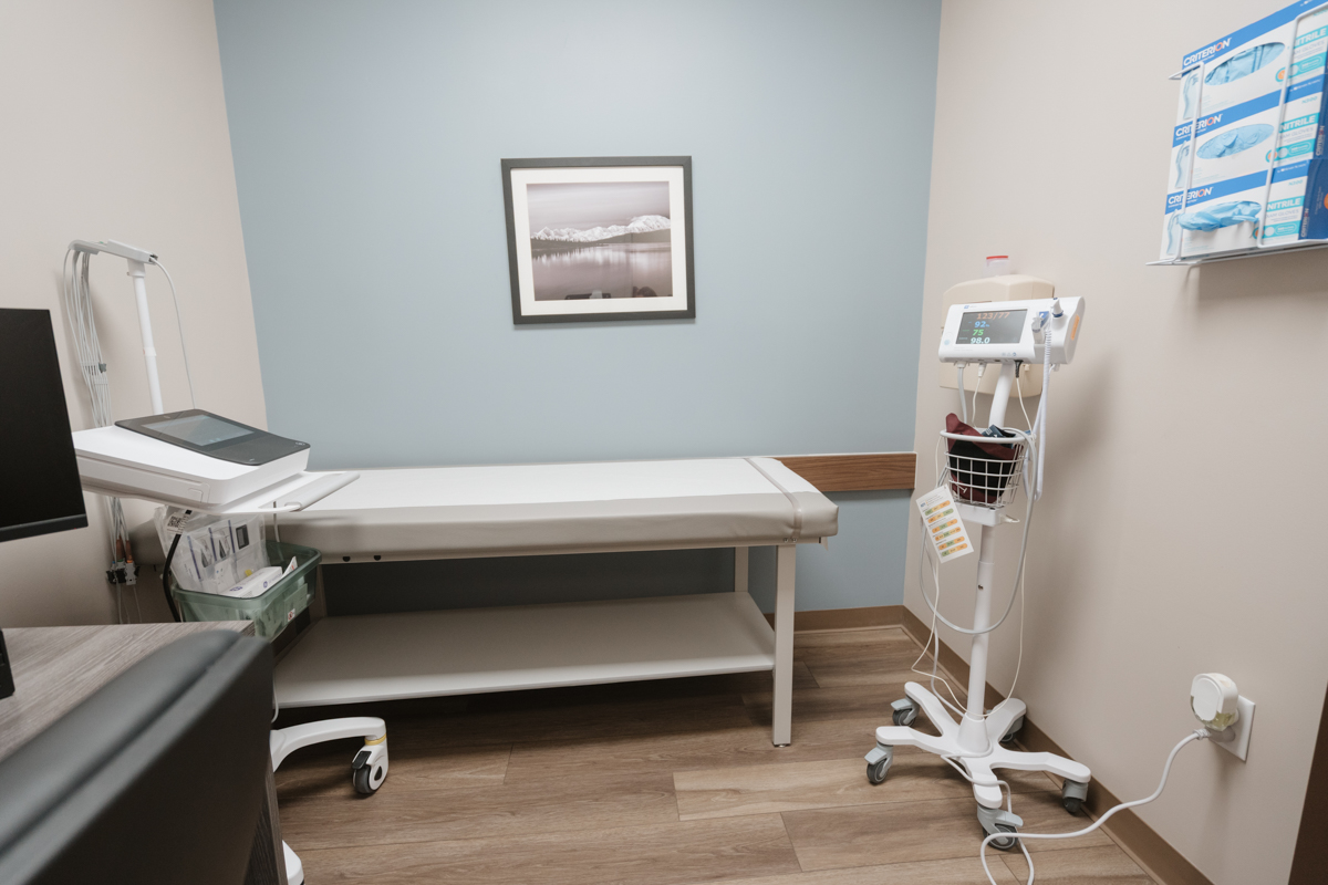 Exam room with treatment table and vital signs monitor
