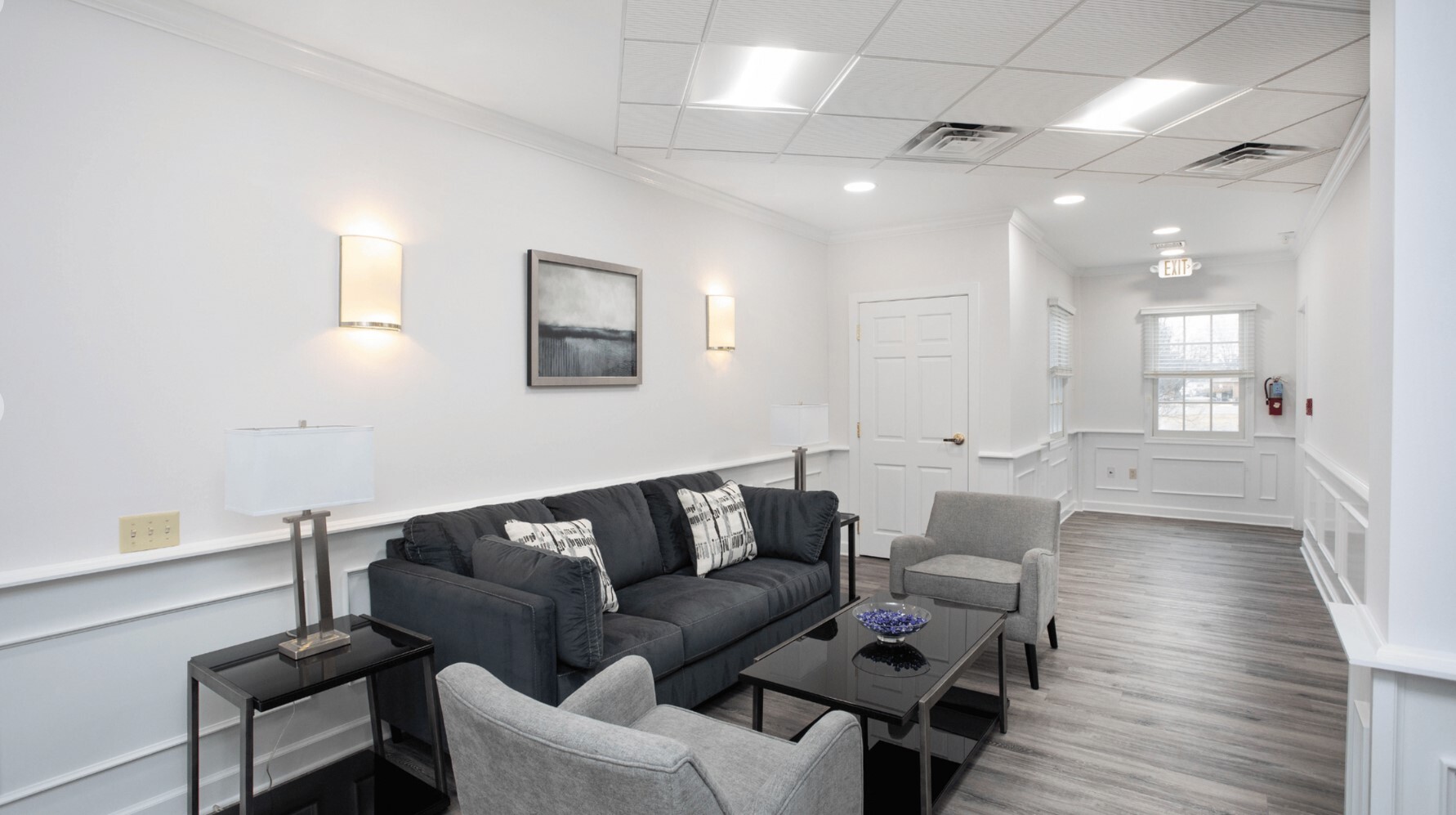 Waiting area with a couch and armchairs.