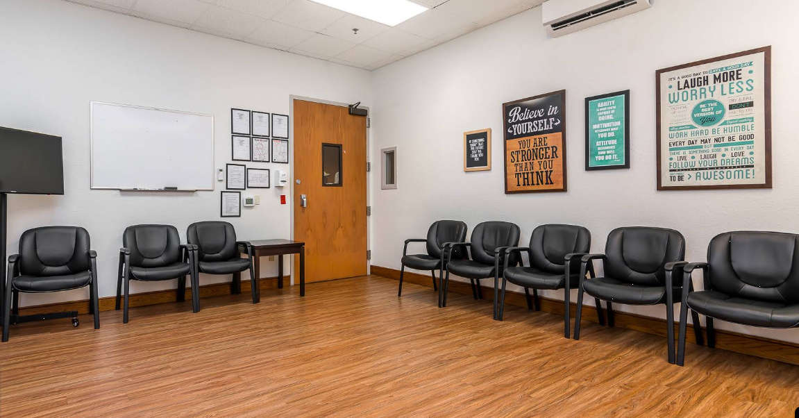 Meeting room with black chairs and inspirational wall art