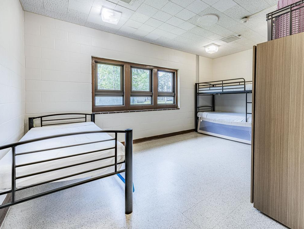 Simple bedroom with single and bunk beds