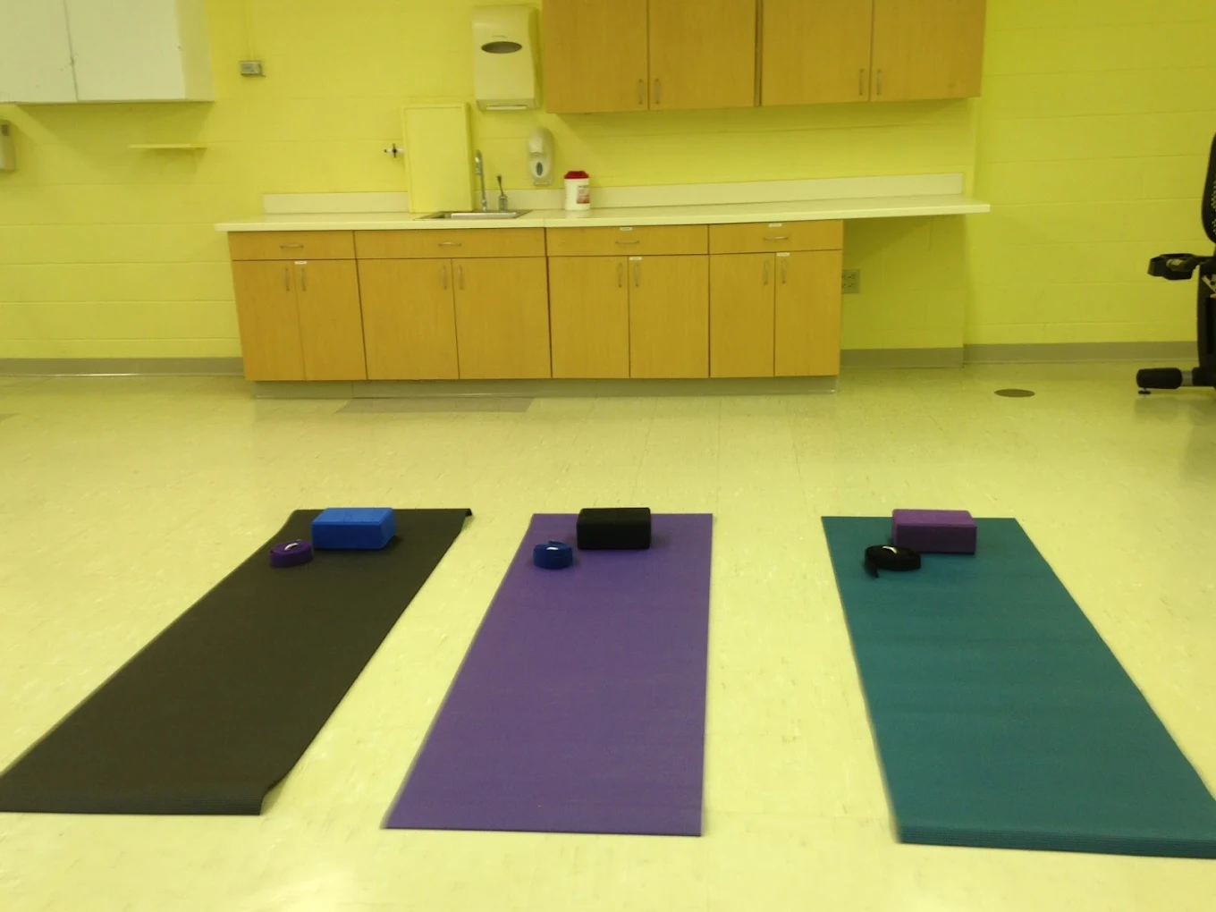 Yoga room with mats and blocks for wellness activities