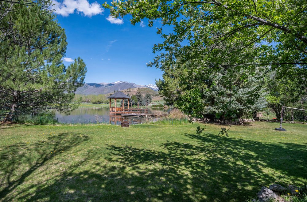 Lakeside gazebo with a field newrby.