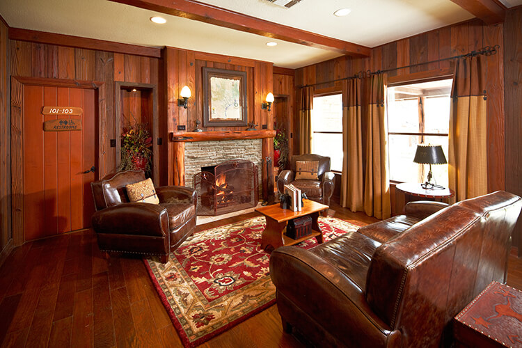 Cozy lounge with leather chairs and stone fireplace