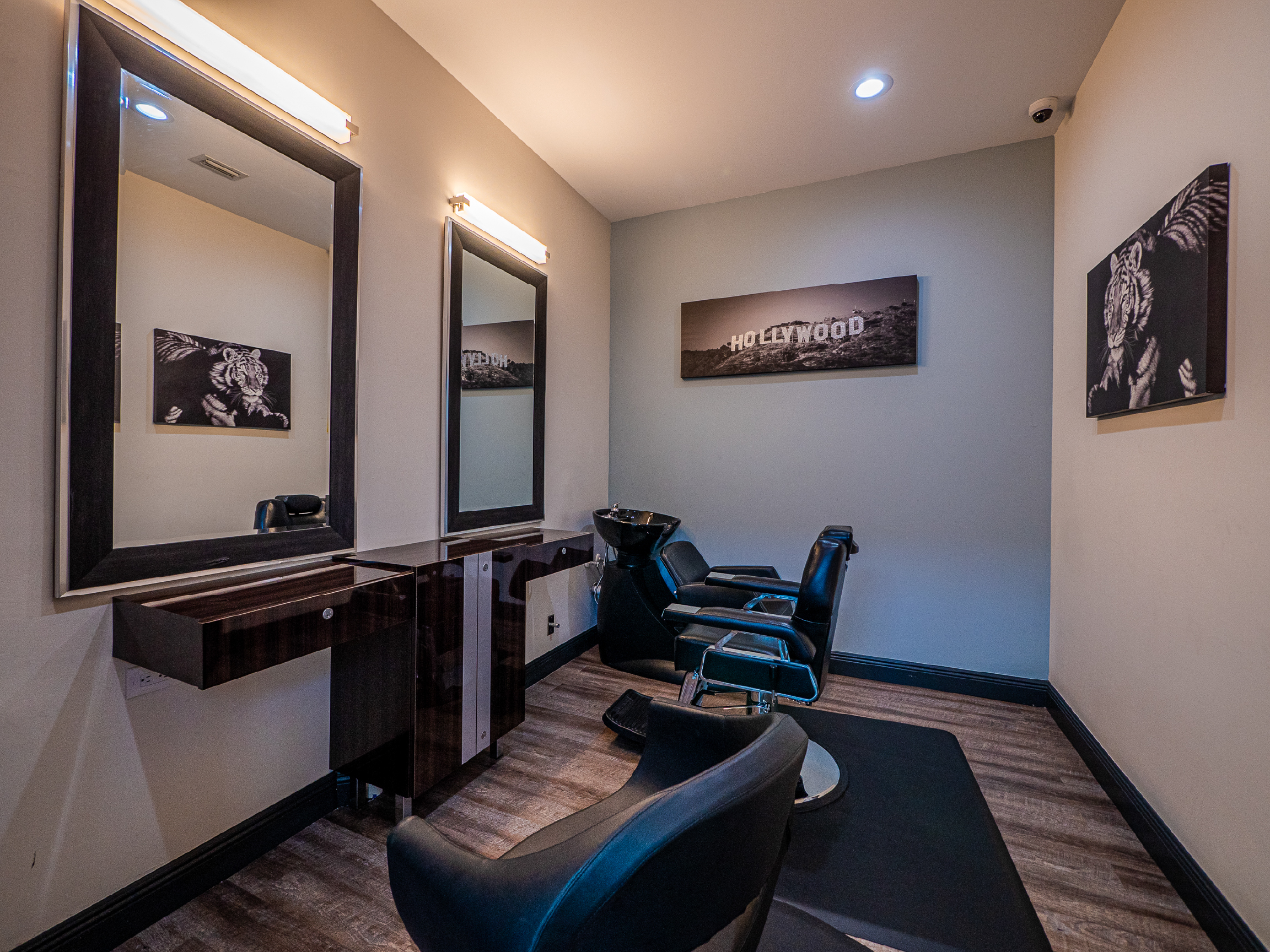 On-site salon room with barber chairs and mirrors.