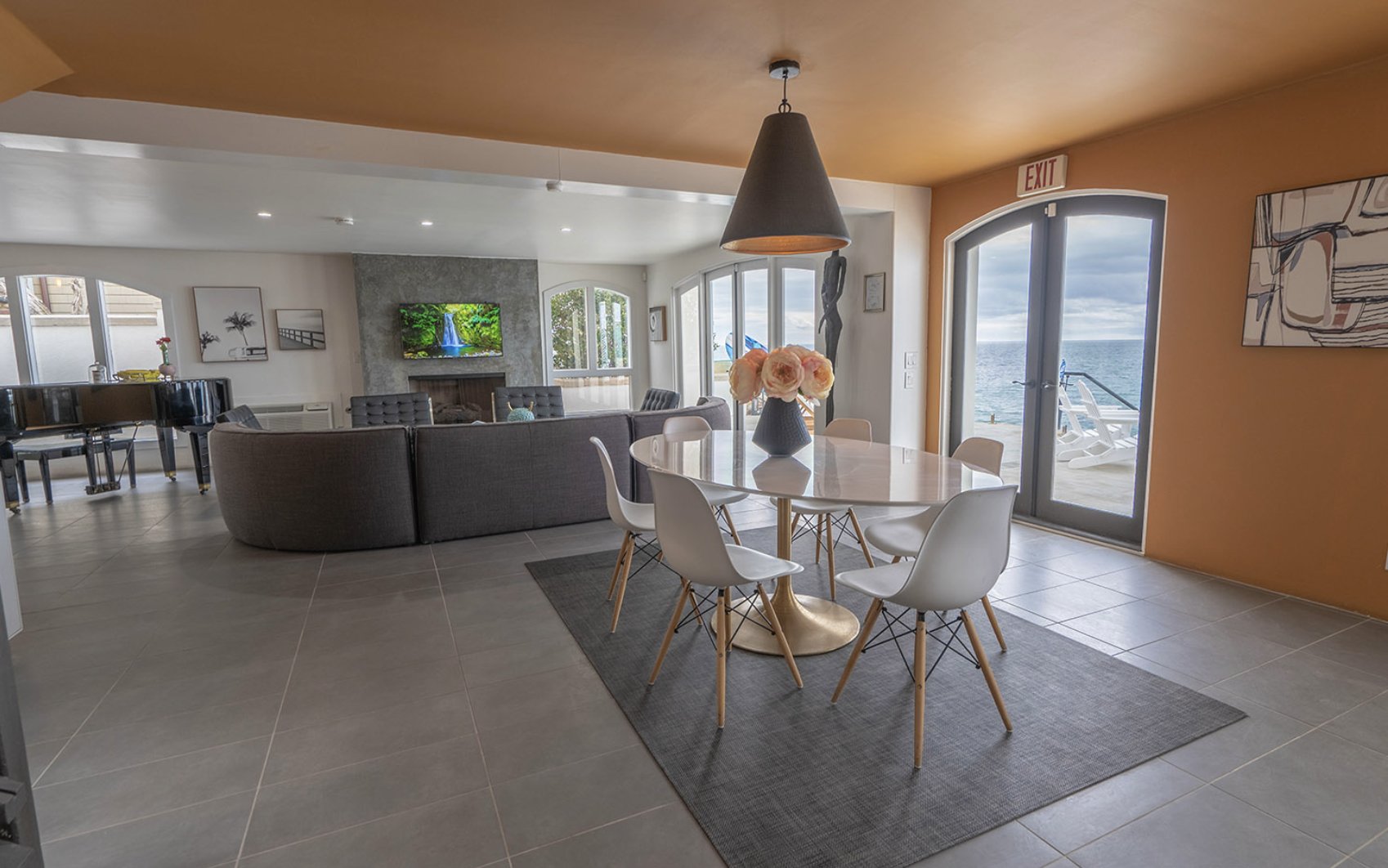 Spacious living room with oceanfront patio access