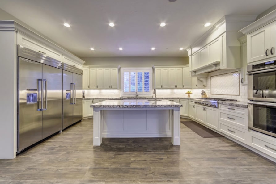 Spacious kitchen with island and stainless appliances
