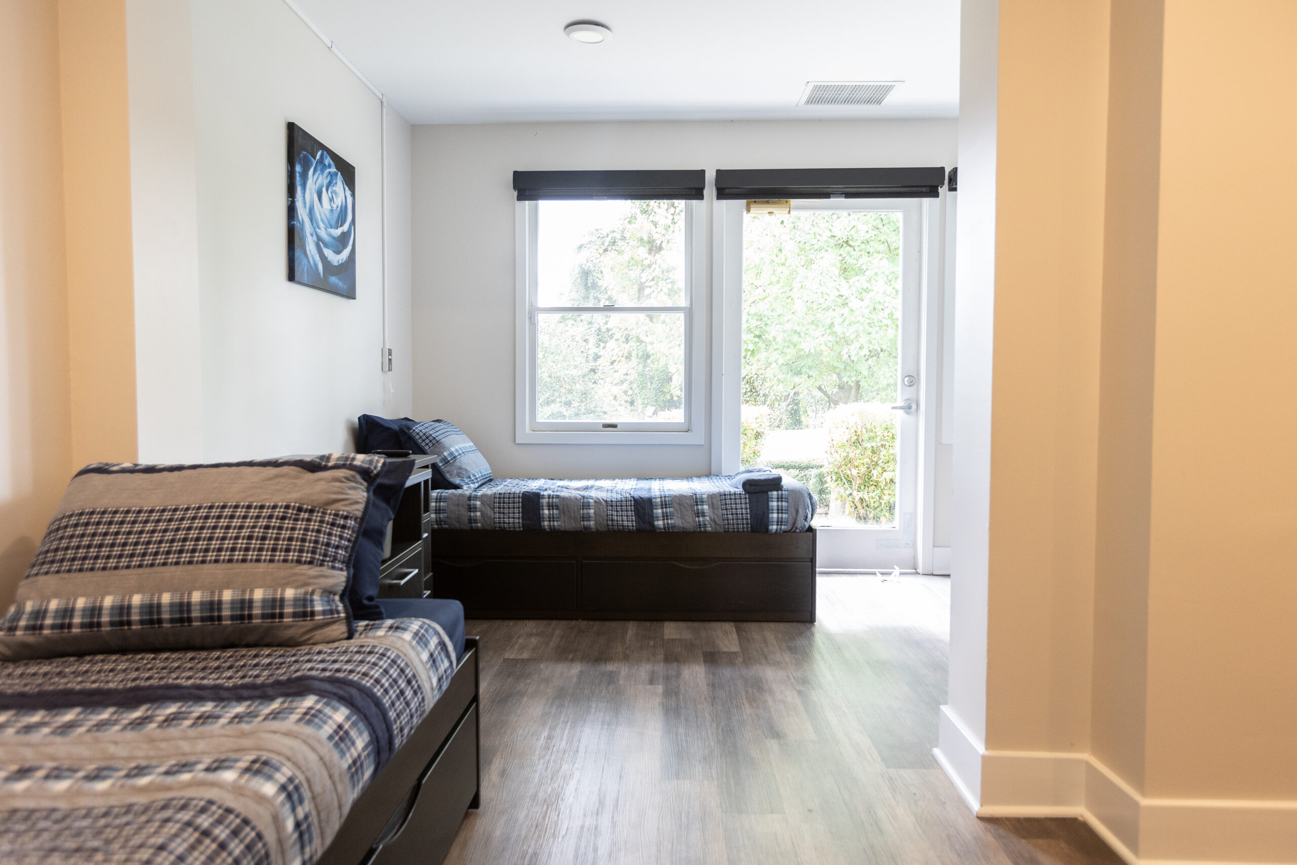 Shared client bedroom with twin beds and natural light