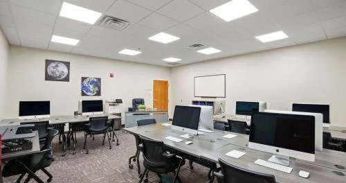 Computer lab with rows of iMac workstations