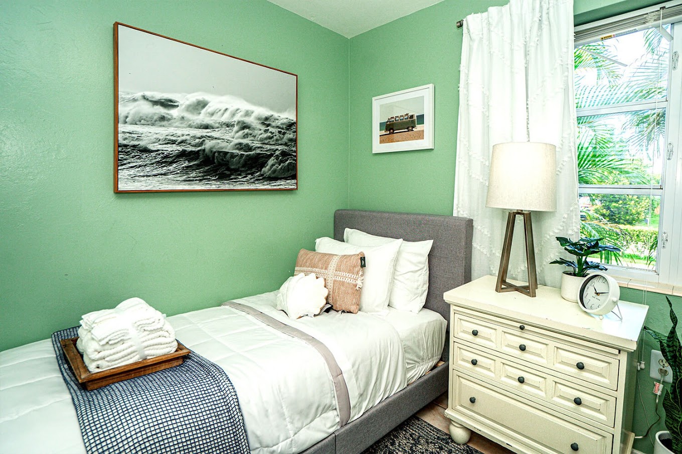 Bedroom with a single bed, dresser, and a window.