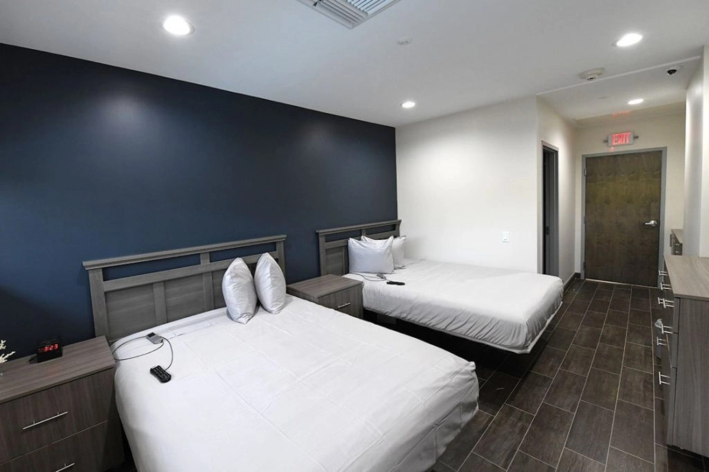 Two neatly made beds in a modern shared recovery room