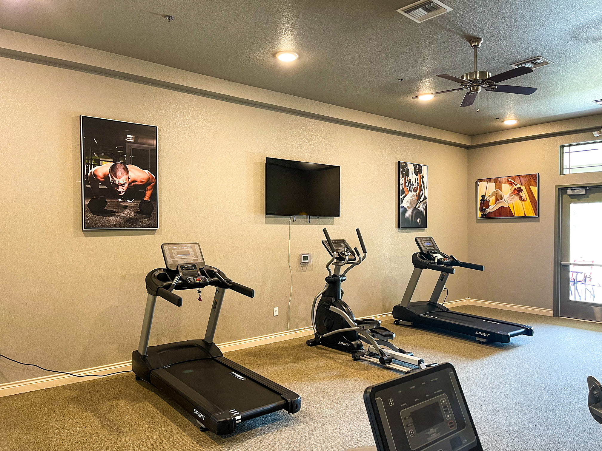 Gym with treadmills and a TV.