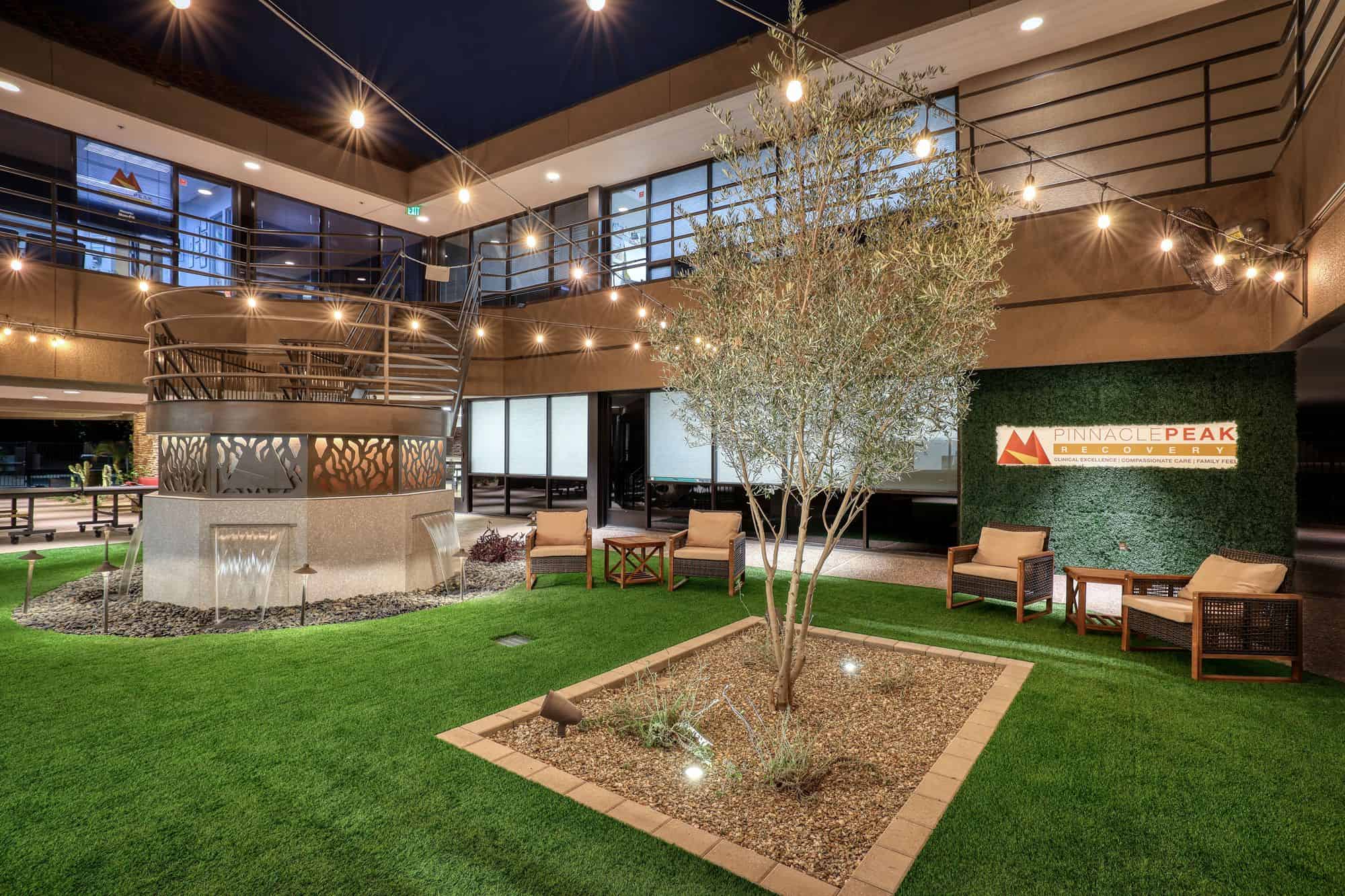 Landscaped courtyard with seating and string lights
