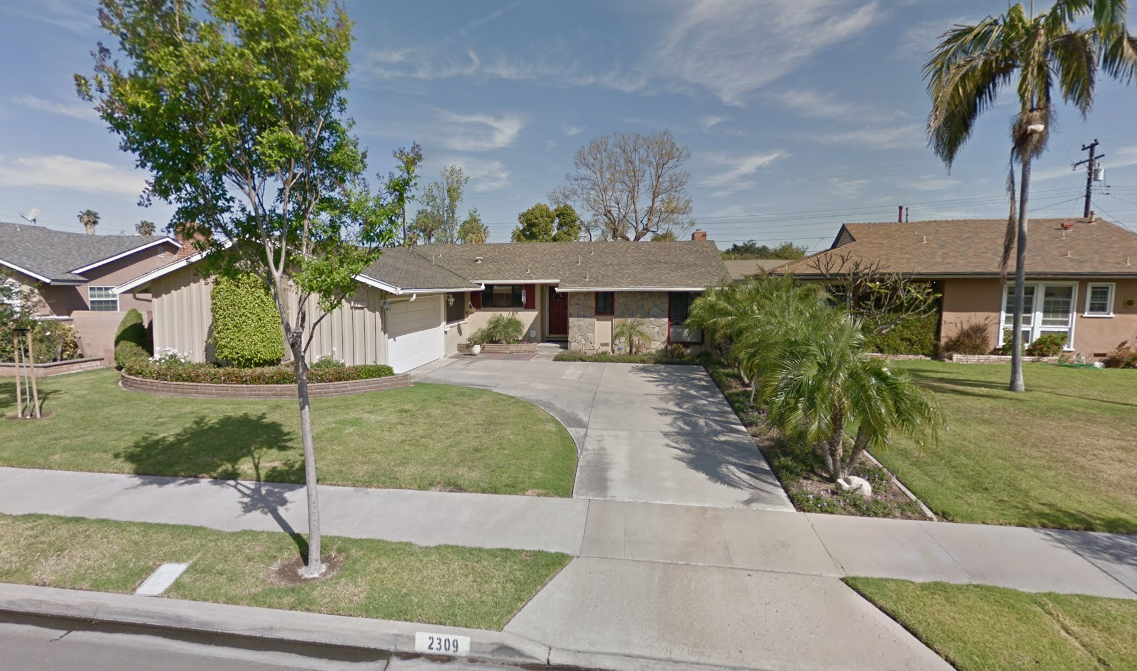 Single-story rehab center with driveway and landscaped front yard